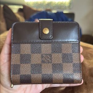 Louis Vuitton Damier Ebene canvas compact wallet.